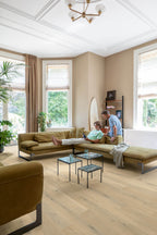 Living room with a beige sectional sofa, coffee tables, and a chandelier.