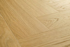 Close-up of a wooden floor with a herringbone pattern