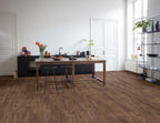 Modern kitchen with wooden dining table and chairs on a wooden floor.