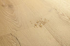 Close-up of a wooden floor with water droplets on it