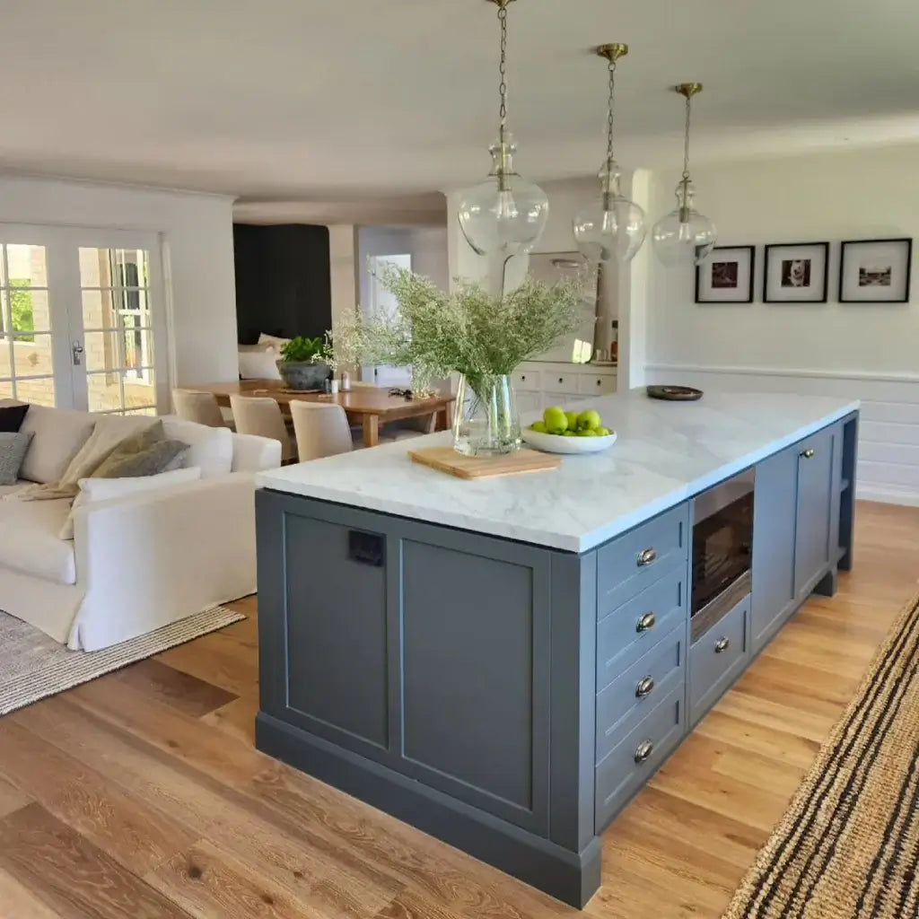 Modern kitchen island with marble countertop in a living room setting