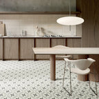 Modern kitchen with wooden cabinets, a dining table, and chairs on a patterned floor.
