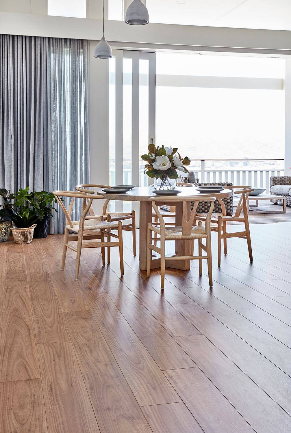 Dining area with wooden table and chairs in a modern home setting.