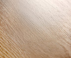 Close-up of a wooden surface with a light brown color and visible grain pattern.