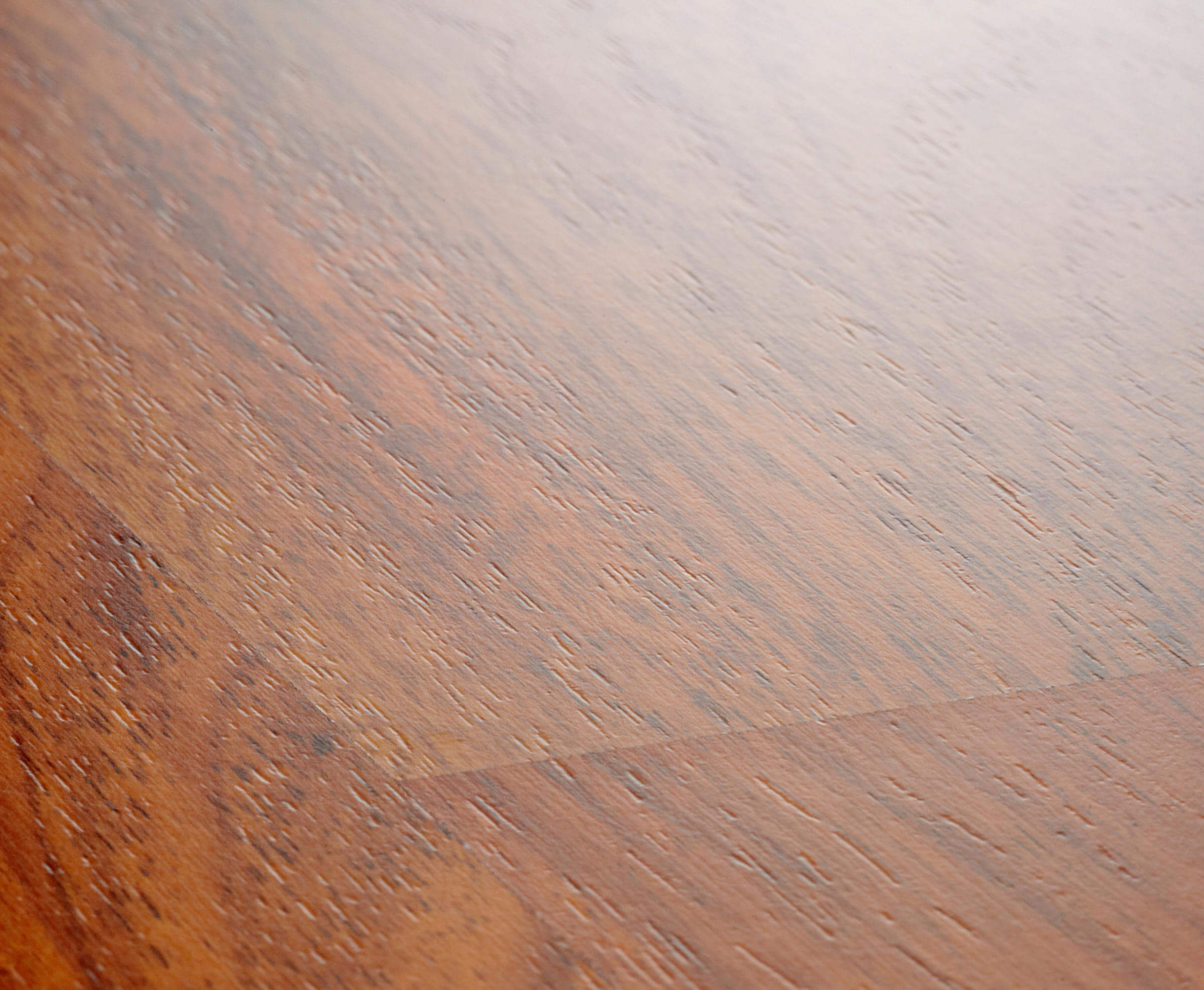 Close-up of a wooden surface with a gradient from brown to gray.