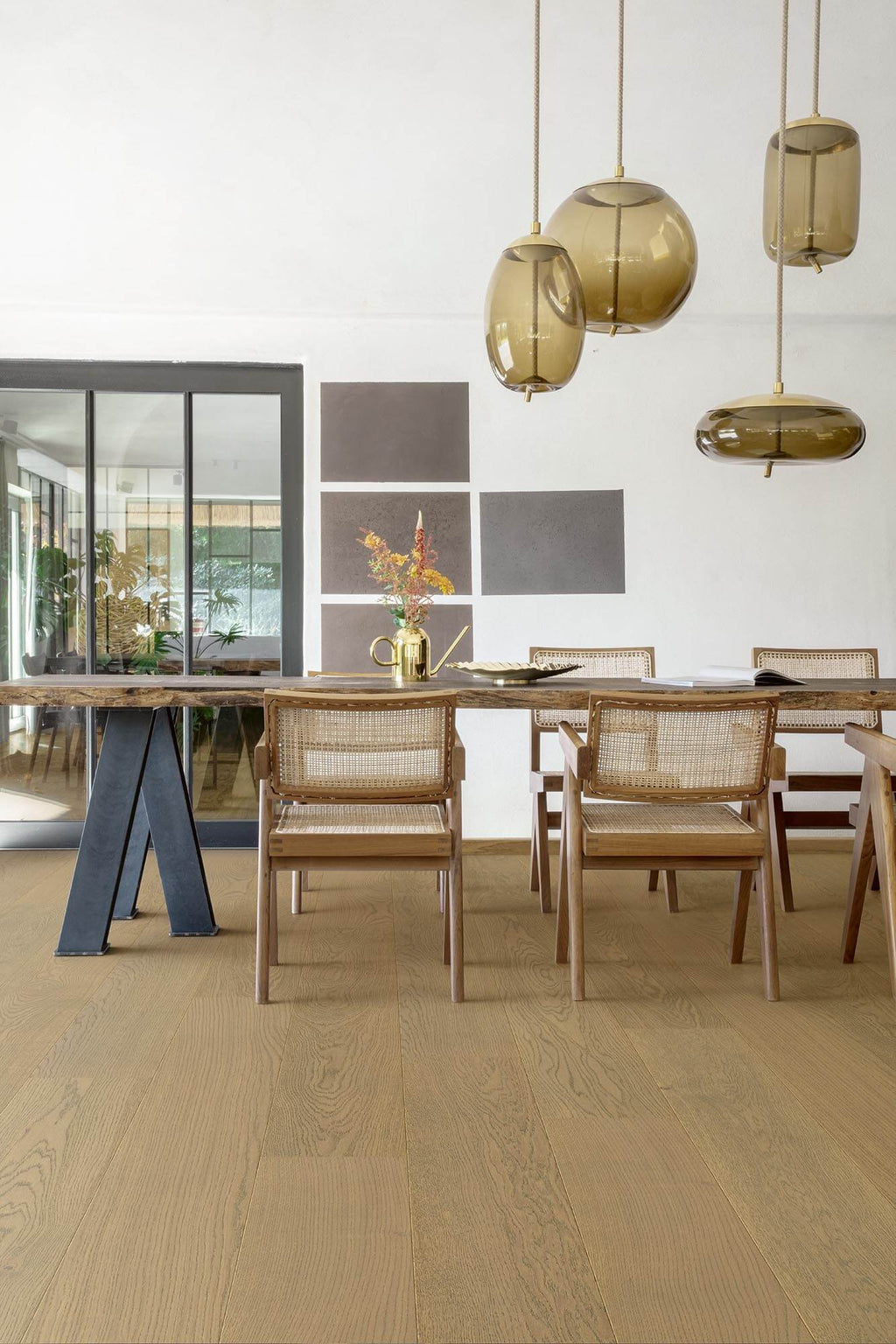 Dining area with wooden table and chairs, modern pendant lights, and a neutral color scheme.
