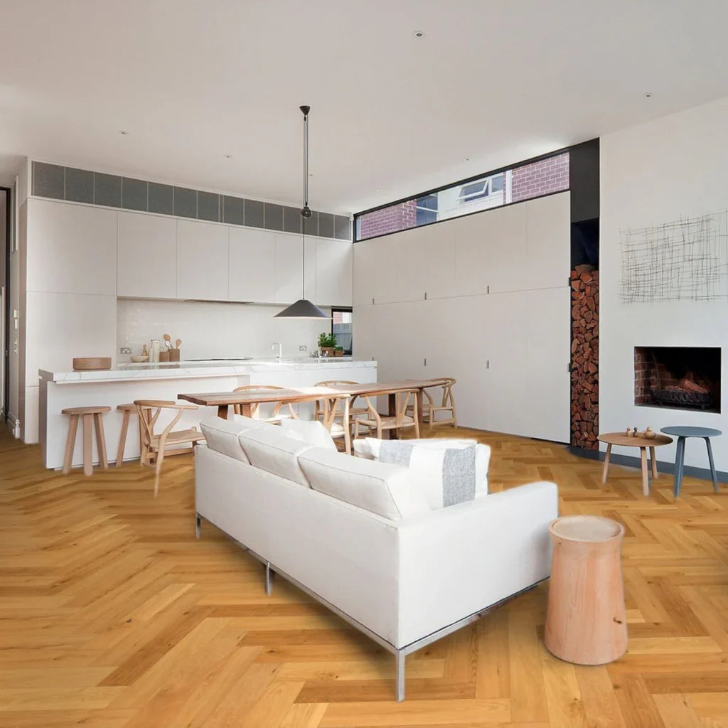 Modern living room with white sofa, wooden floor, and kitchen area.