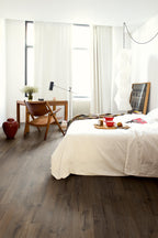 Modern bedroom with a bed, desk, and window