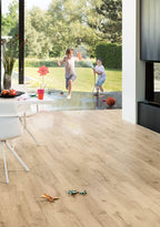 Children playing in a modern living room with wooden flooring.