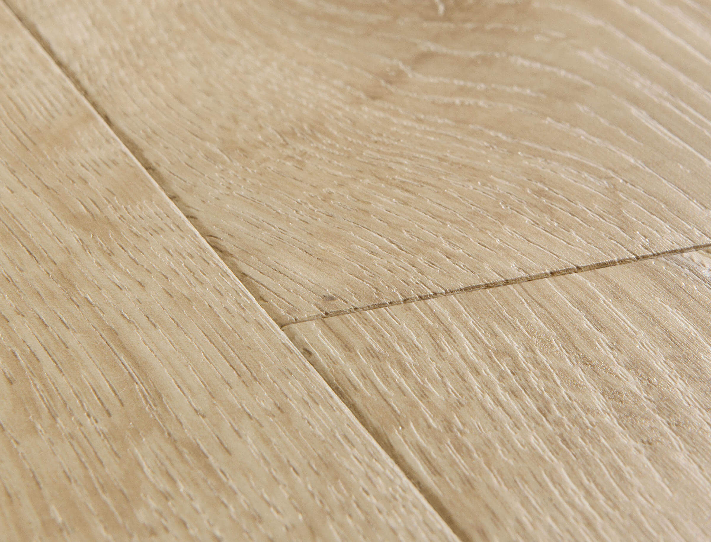 Close-up of a wooden floor with light brown planks.