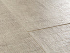 Close-up of a textured beige floor with a visible seam.