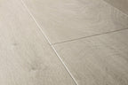 Close-up of light gray tiles with a wood-like texture