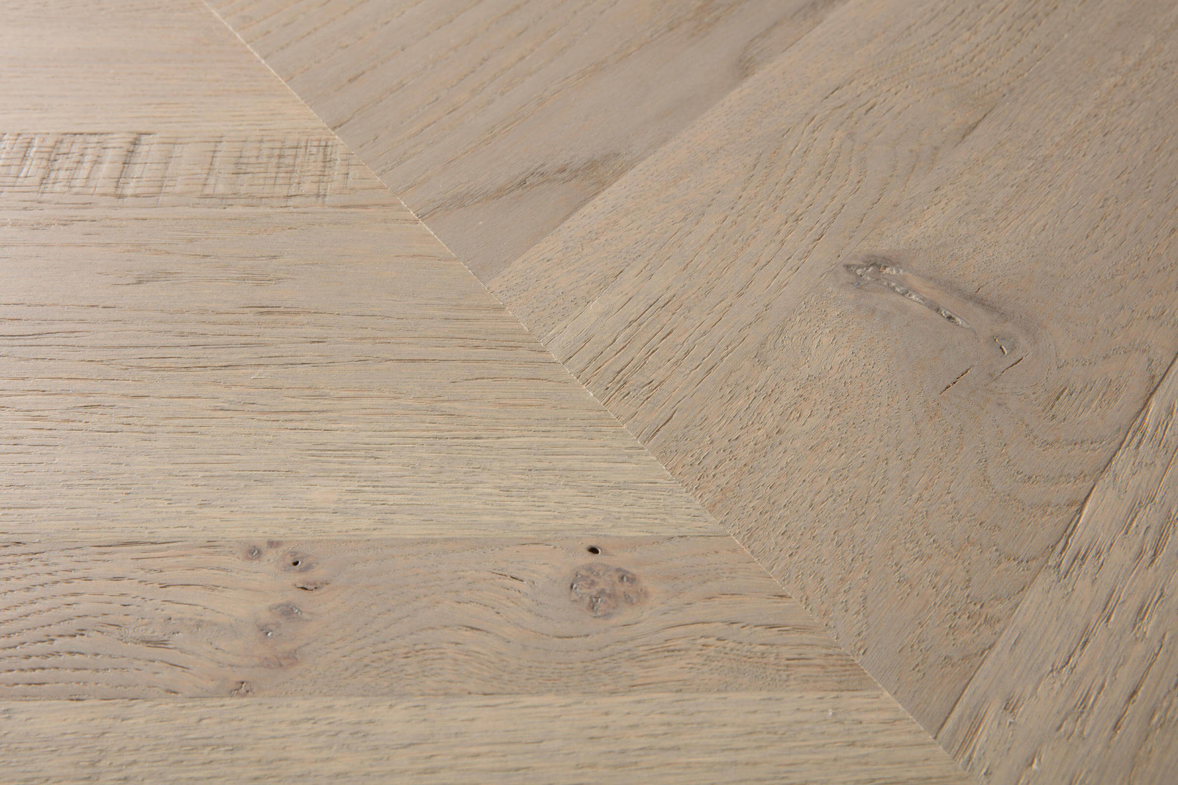 Close-up of wooden flooring with a herringbone pattern