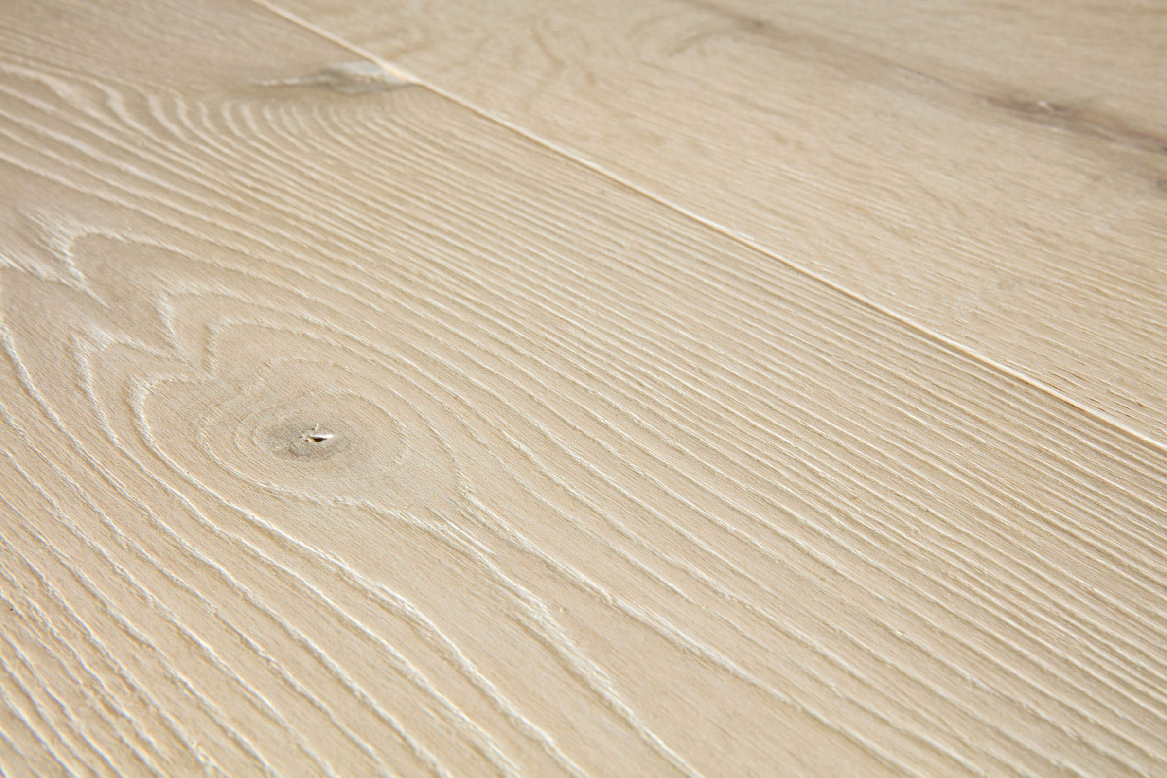 Close-up of a beige wooden surface with visible grain patterns