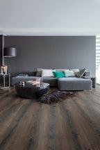 Modern living room with a gray sectional sofa, coffee table, and decorative items.