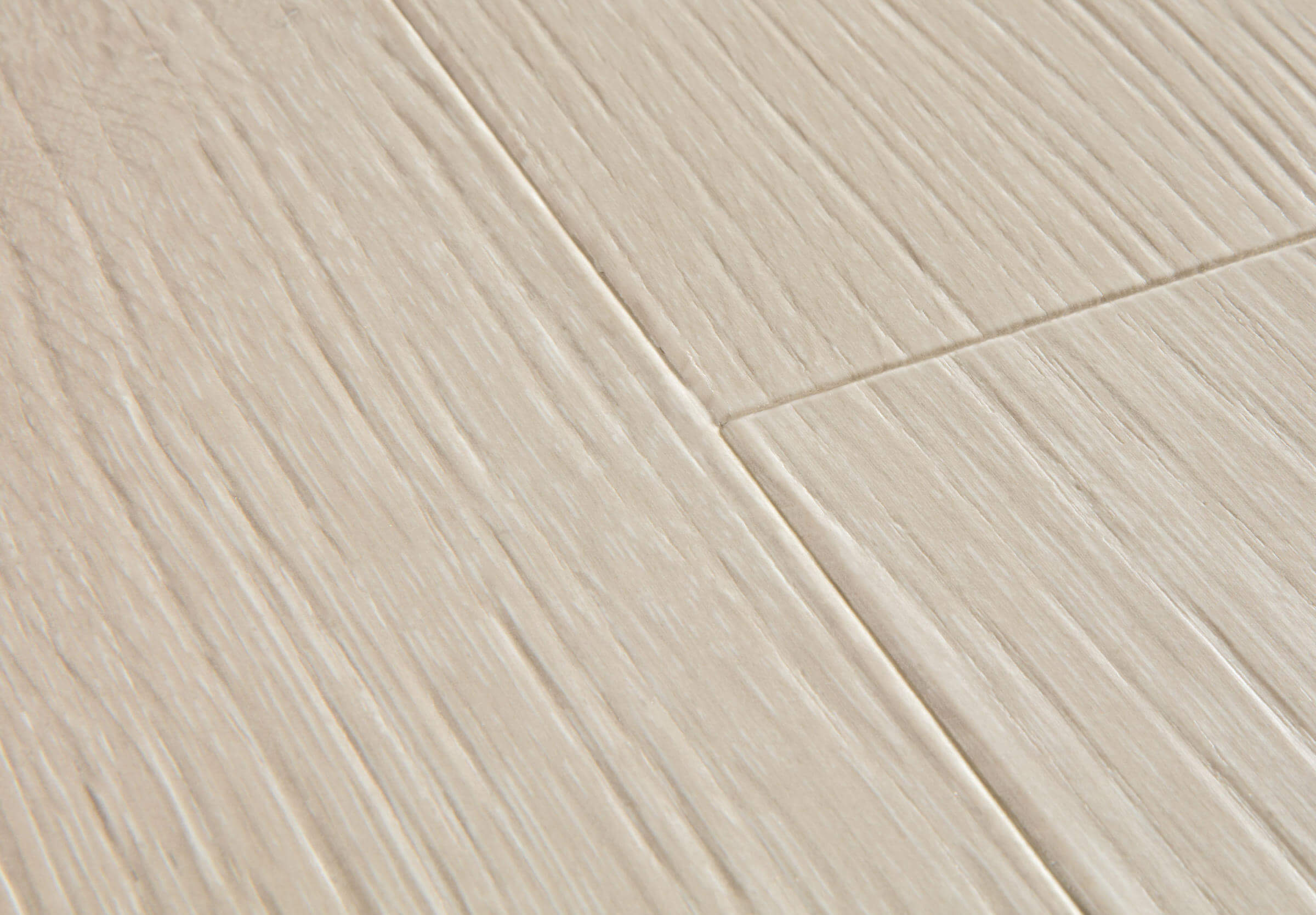 Close-up of a tiled floor with beige tiles