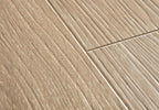Close-up of beige ceramic tiles with a herringbone pattern