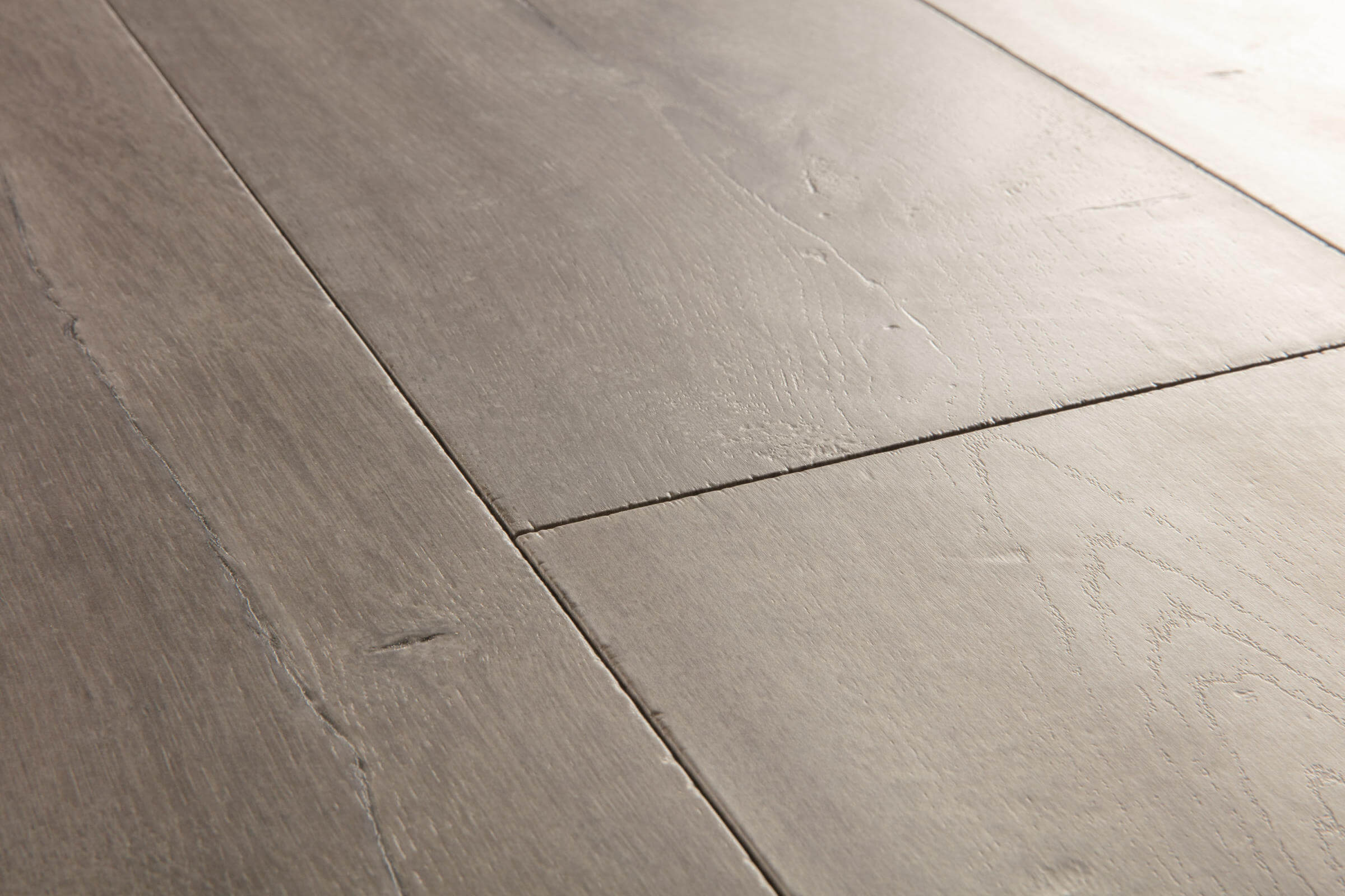 Close-up of gray wooden flooring with a focus on texture and pattern.