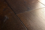 Close-up of dark wooden flooring with visible grain and texture.