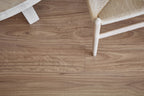 Wooden floor with a chair leg partially visible