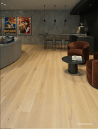 Living room with wooden flooring, furniture, and wall art.