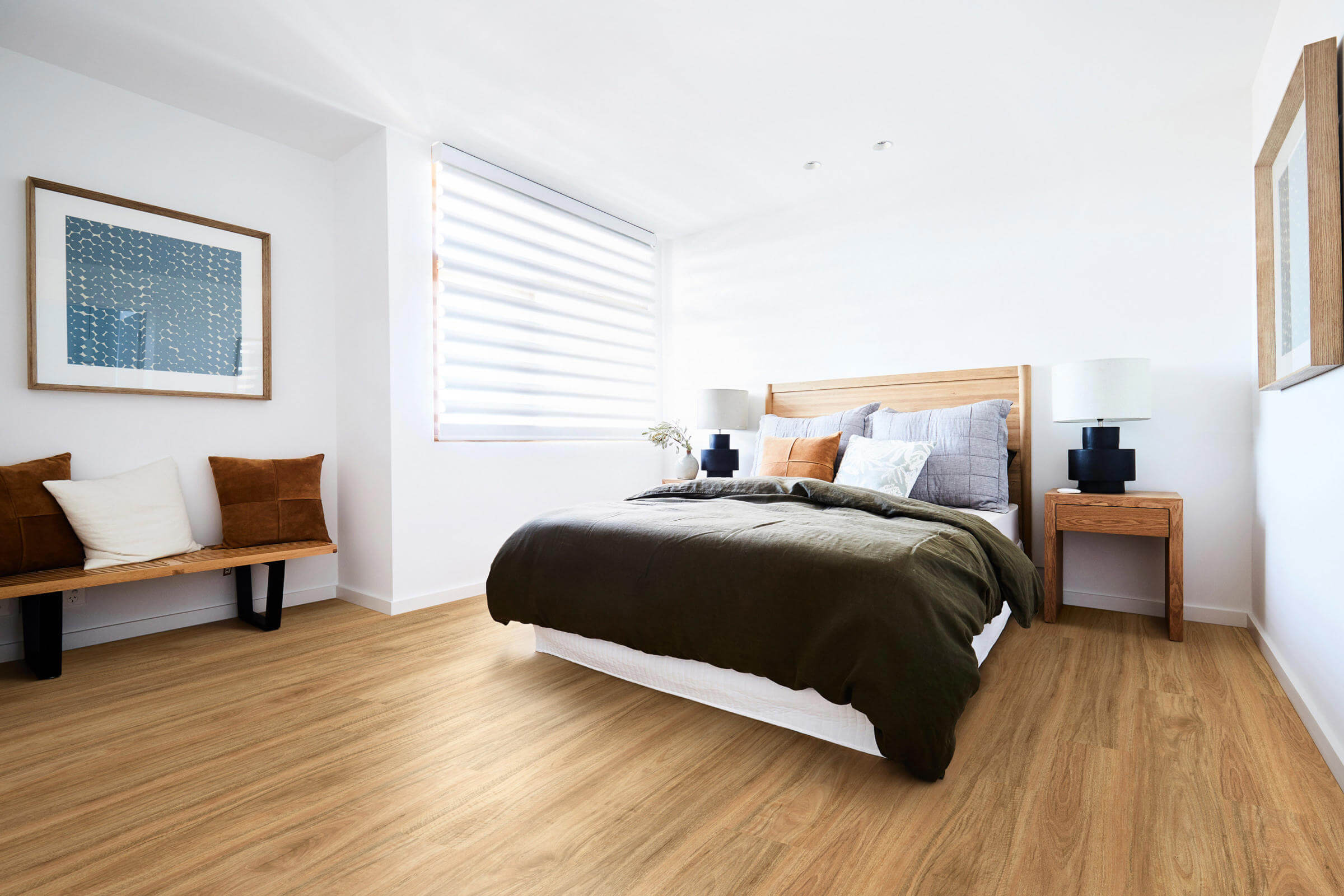 Modern bedroom with wooden floor, bed, and decor