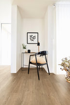 Modern interior with a desk, chair, and decorative items on a wooden floor.
