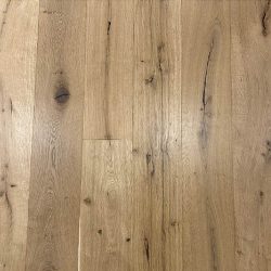 A close-up timber flooring sample of Arcadian RAW Rustic Grade oak, showcasing its beautifully raw, unfinished character with prominent knots, natural cracks, and rich variation in grain and tone that bring an authentic, lived-in warmth to any home interior.
