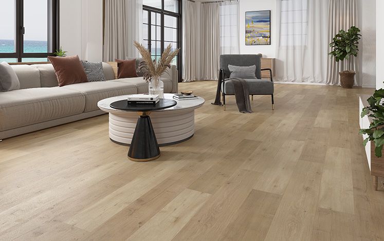Modern living room with wooden flooring, furniture, and large windows.