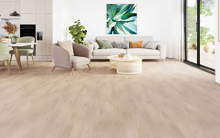 Modern living room with light wood flooring, furniture, and a painting on the wall.