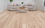 Living room with light wood flooring, gray sofa, and decorative items.