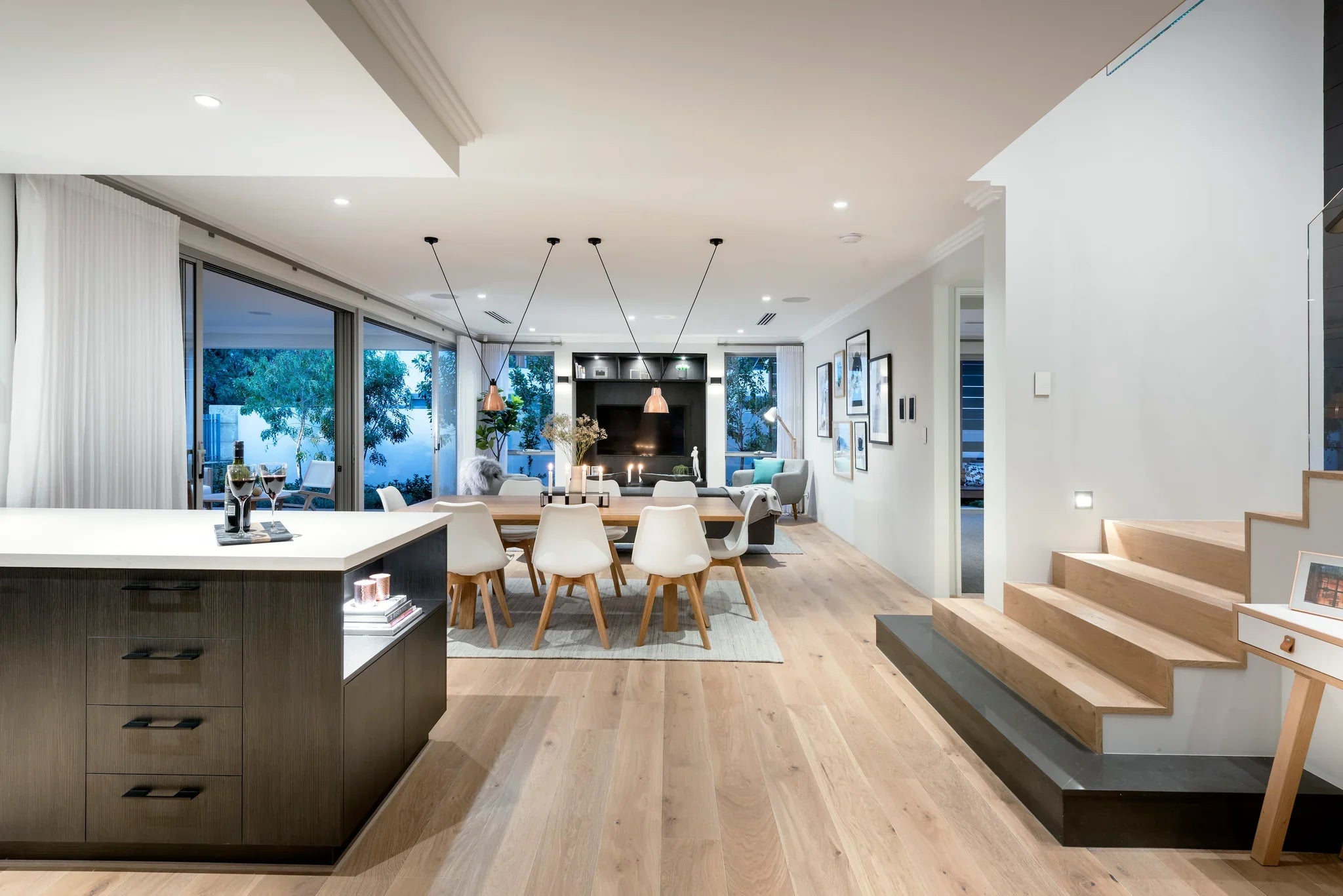 Modern open-plan living area with kitchen, dining, and living room.