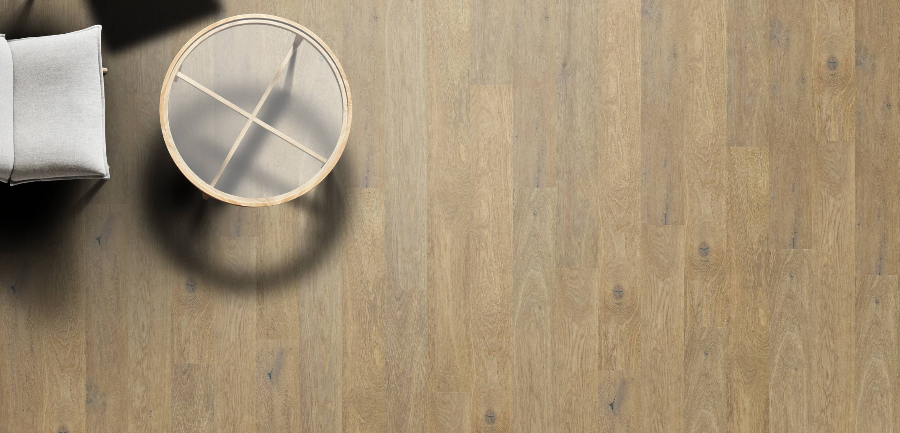 Wooden flooring with a round table and chair in a minimalistic setting