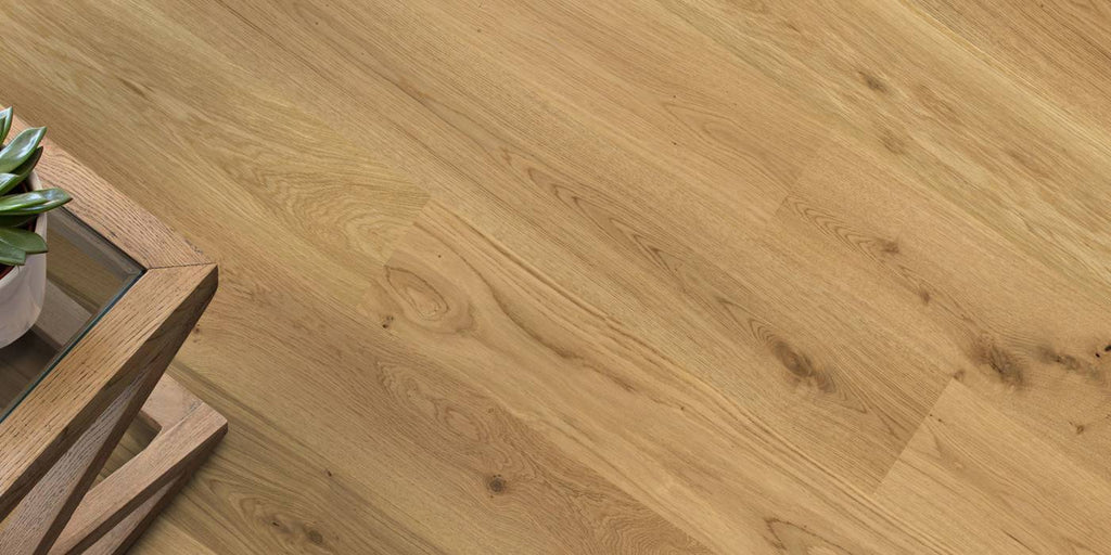 Wooden floor with a small table and plant in the corner