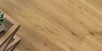 Wooden floor with a small table and plant in the corner