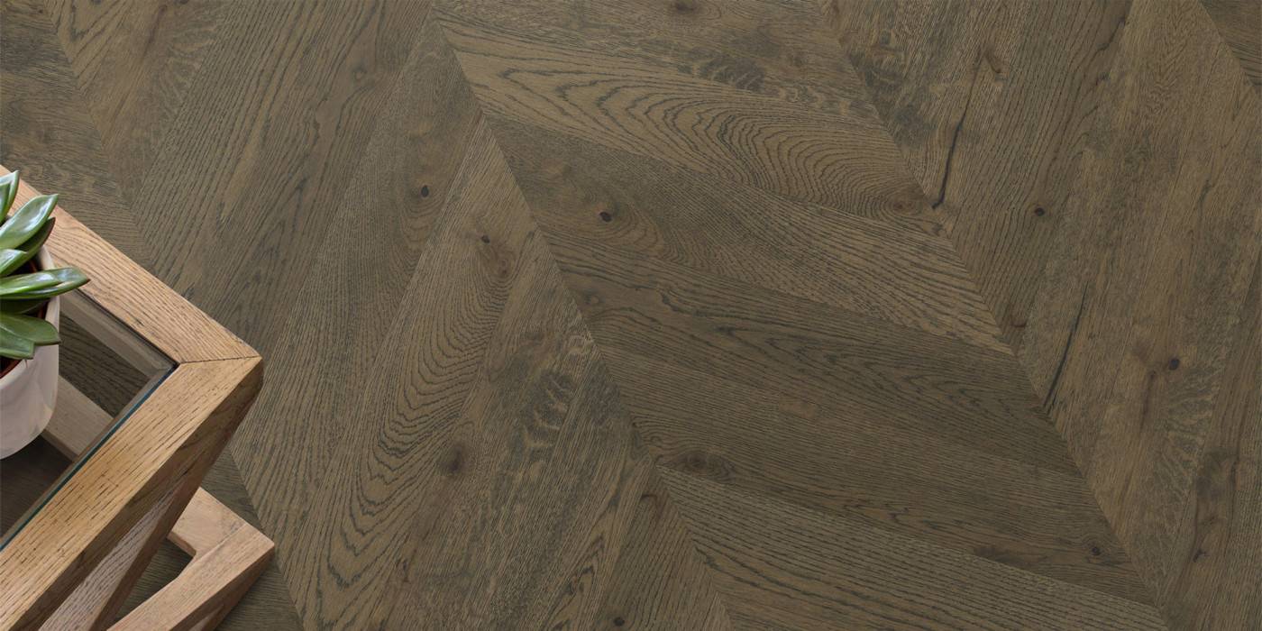 Close-up of a wooden floor with a herringbone pattern