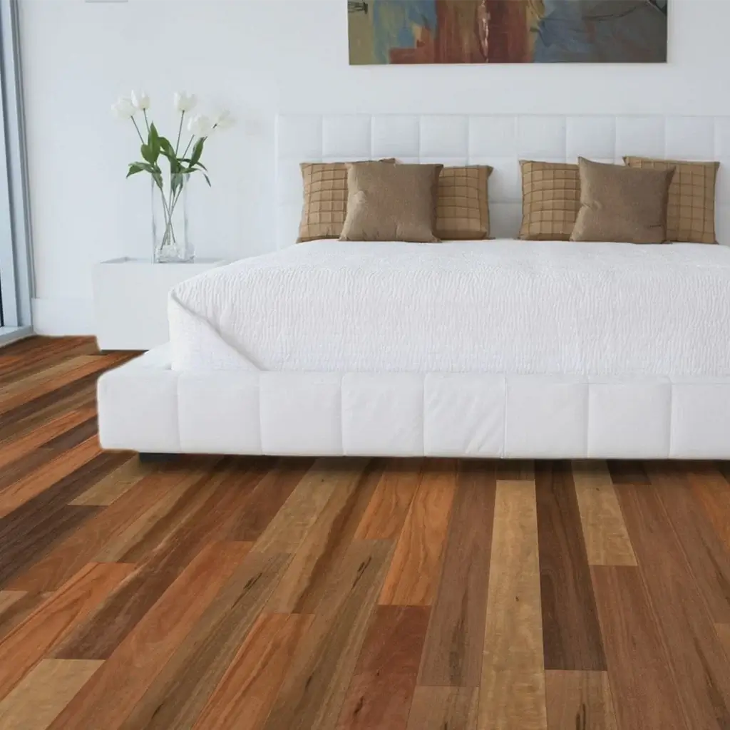 Modern bedroom with a white bed, wooden floor, and abstract painting on the wall.