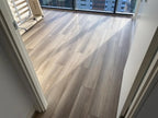 Wooden flooring in a room with large windows