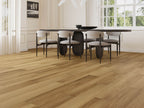 Dining room with wooden flooring, table, and chairs.
