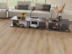Modern living room with a sectional sofa and coffee table set on a wooden floor.