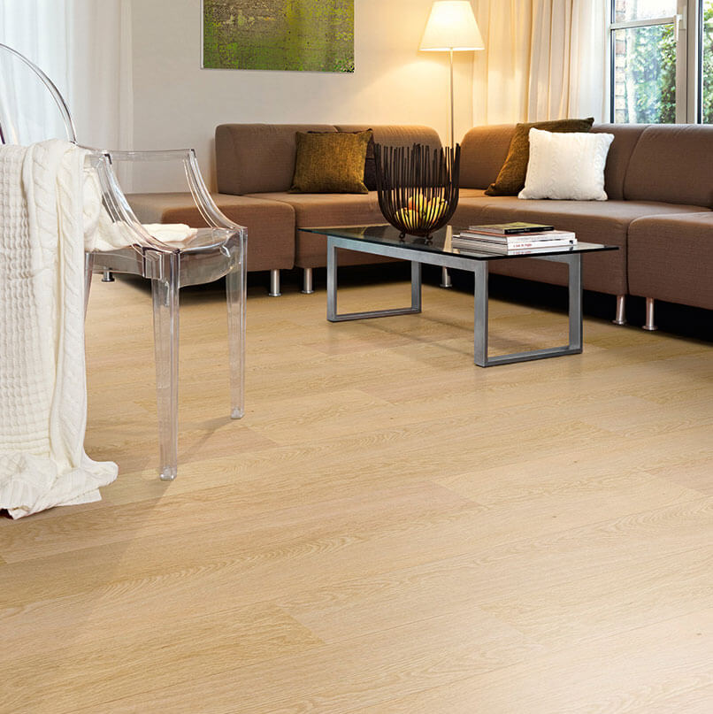 Living room with wooden flooring, sofa, and coffee table.