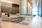 Modern living room with white sofa, coffee table, and decorative elements.